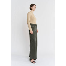 Load image into Gallery viewer, Woman wearing a beige sweater and green wide-leg pants on a white background
